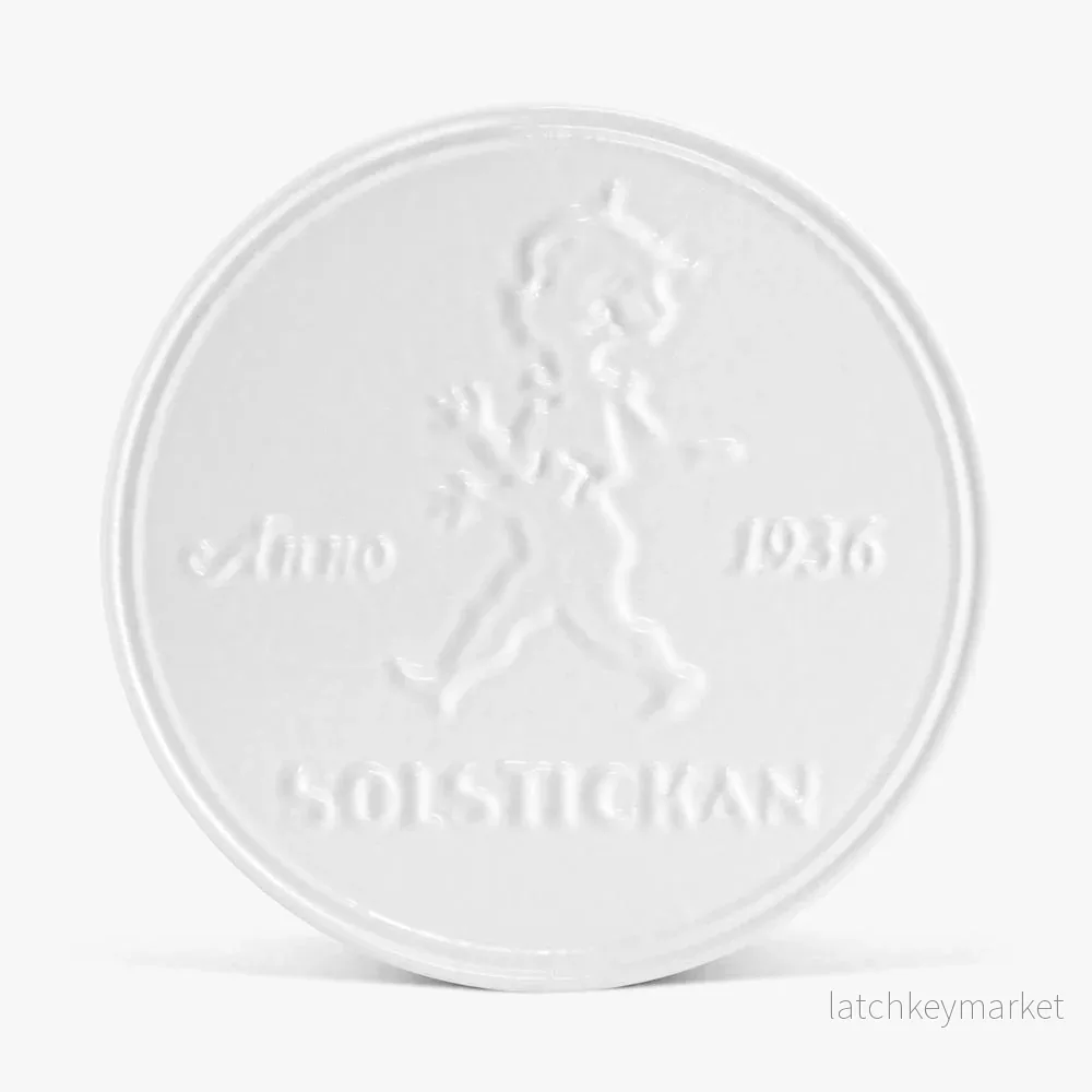 Solstickan grytunderlägg i gjutjärn vitt